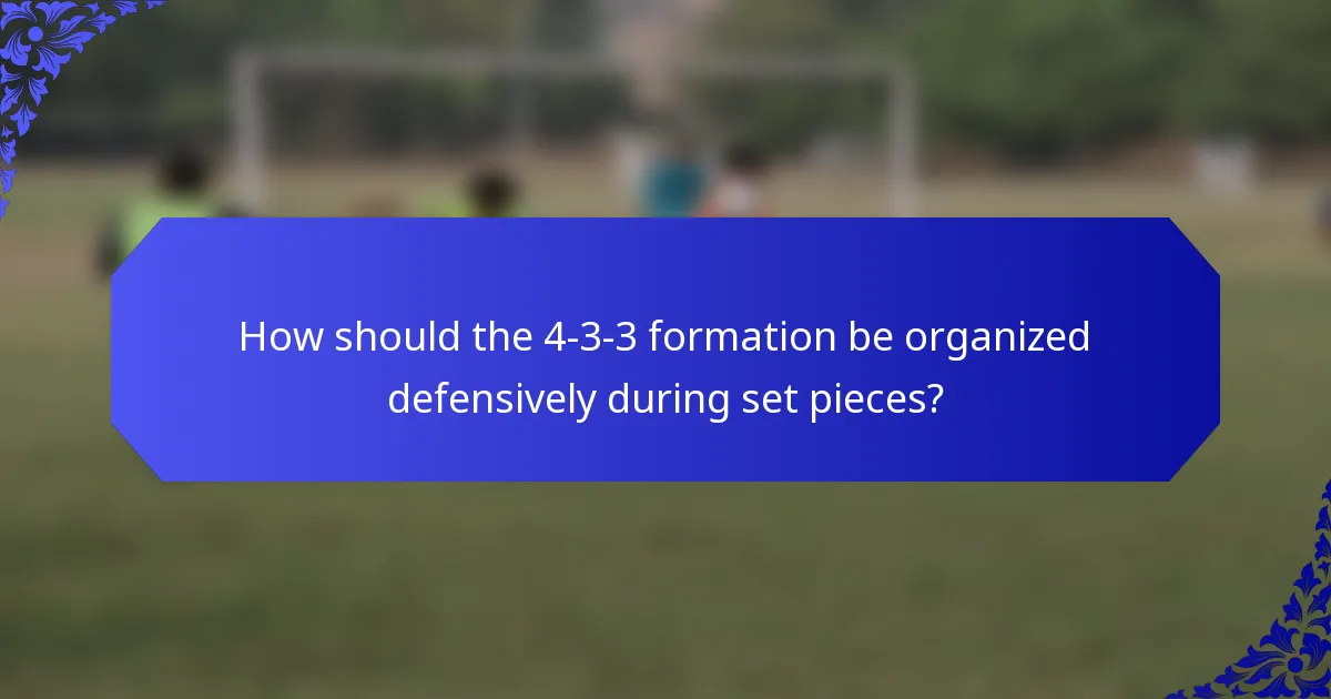 How should the 4-3-3 formation be organized defensively during set pieces?